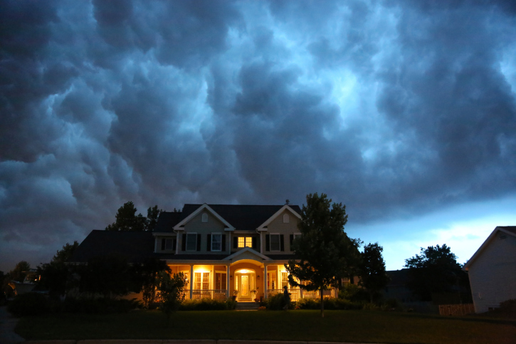 image of house with storm clouds behind it