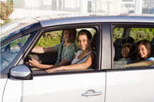 image of family sitting in car