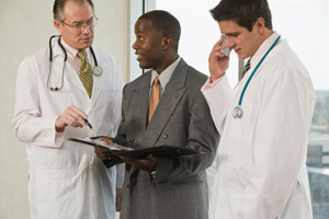 image of doctors talking with business man